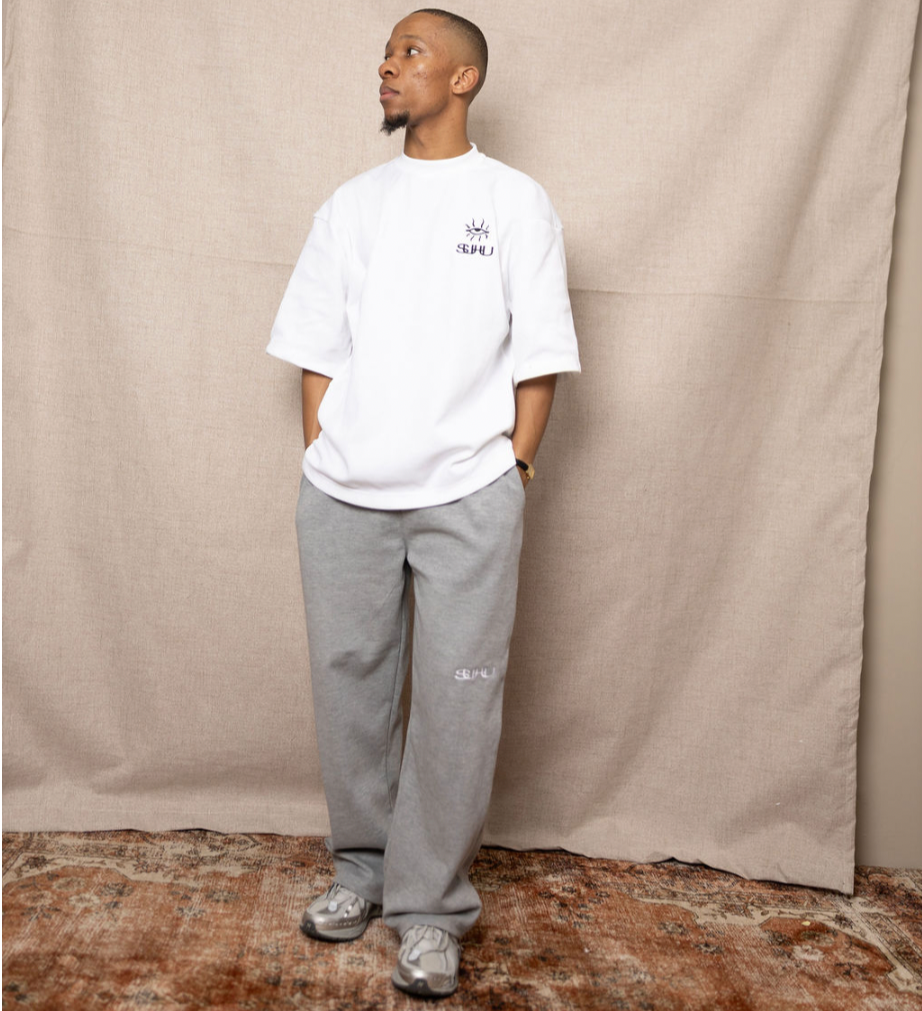 Model in SUHU Grey Sweats and white t-shirt