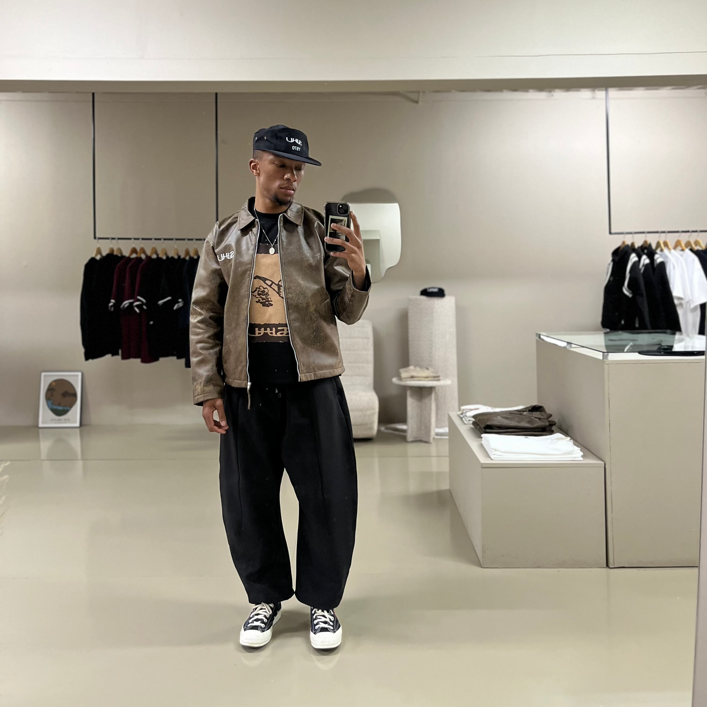 SUHU Barrel Leg pants worn by model in front of the SUHU store mirror.