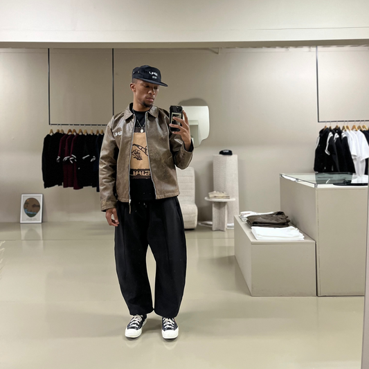 SUHU Barrel Leg pants worn by model in front of the SUHU store mirror.