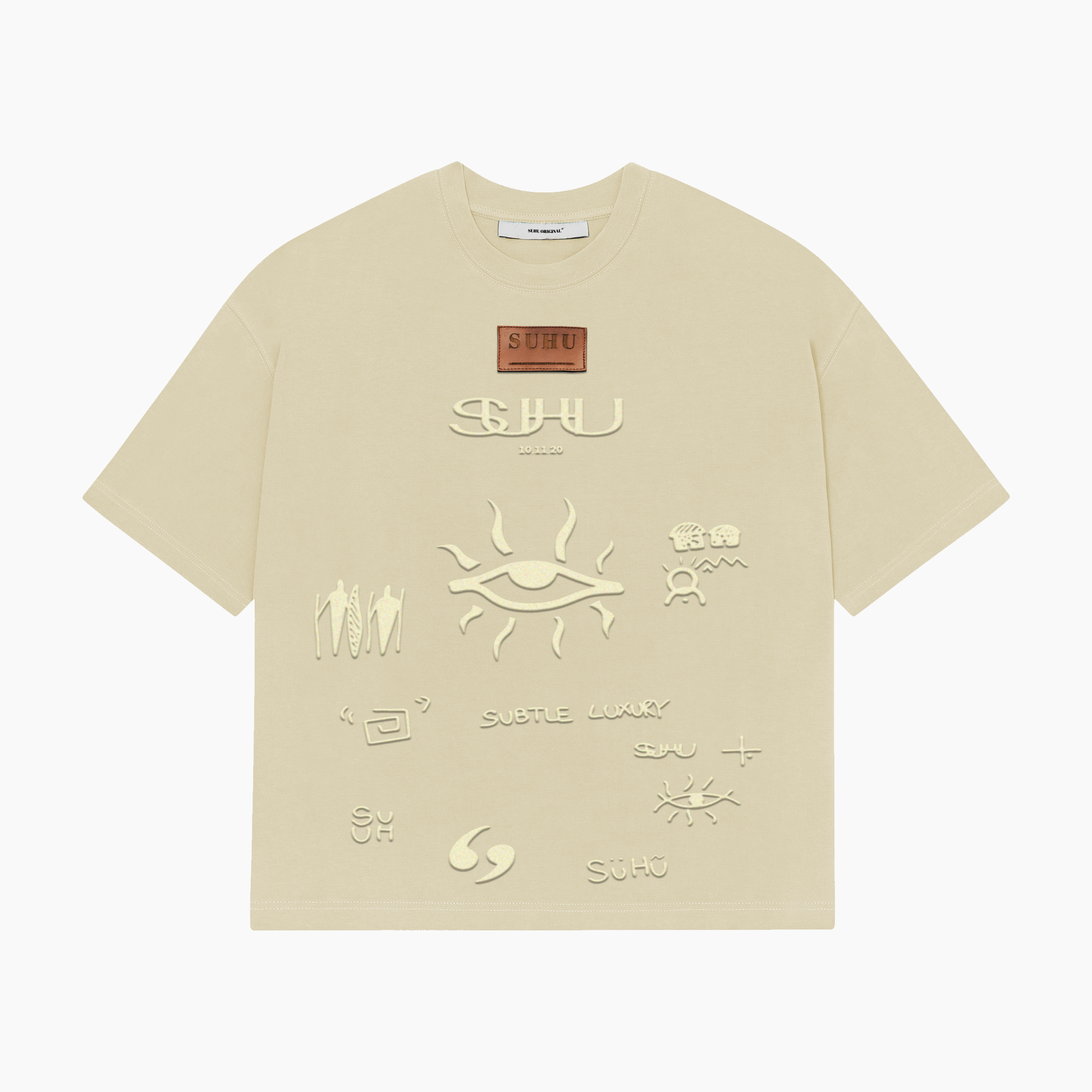 A beige SUHU t-shirt with various text and symbol embossments on the front, featuring the puff print SUHU symbols.